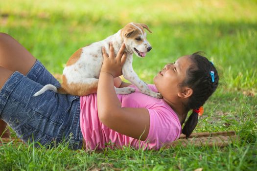 little asian girls and puppy in the garden