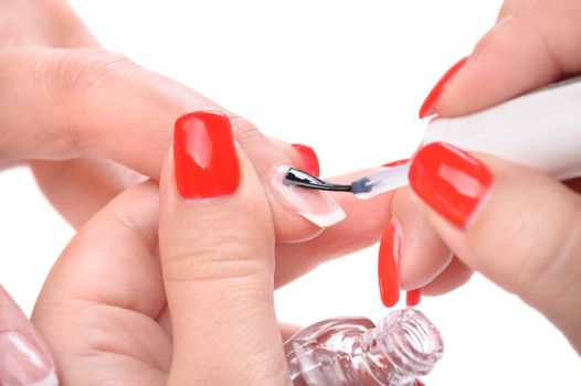 manicure applying, brushing fingernails with clear enamel