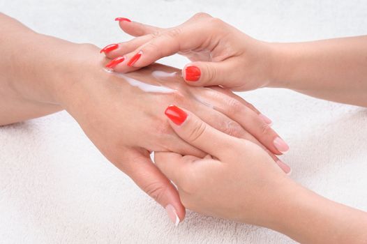 beauty salon, applying moisturizing cream onto the hands and massaging