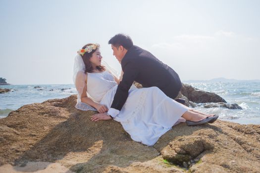 Happy young asian couple in love outdoor on the beach