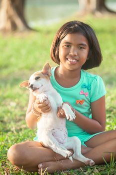 little asian girl and puppy in the garden