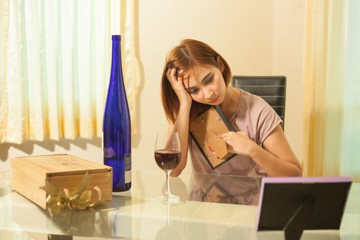 Young beautiful asian woman in depression, drinking alcohol