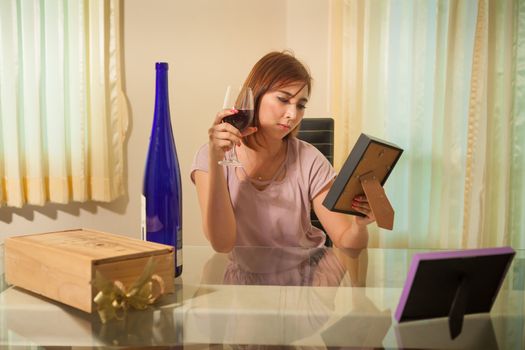 Young beautiful asian woman in depression, drinking alcohol