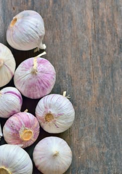 Fresh garlic isolated on old wooden background, top view