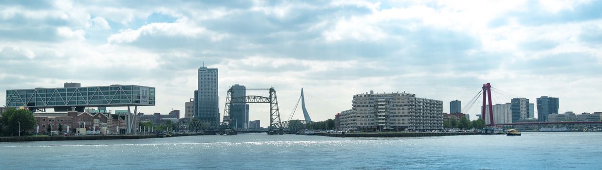 ROTTERDAM, NETHERLANDS - MAY 30, 2014: The modern skyline of Rotterdam with the Unilever building and its numerous bridges, mainly from left to right: De Hef (old lifting bridge for trains), Erasmusbrug, and Willemsbrug on May 30, 2014 in Rotterdam, the Netherlands.