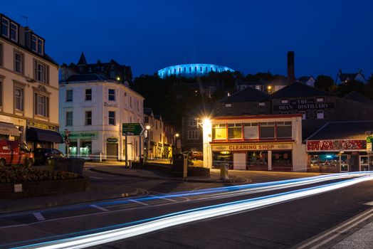 OBAN, SCOTLAND - June 3,2014: The illuminated McCaig's Tower (also known as McCaig's Folly) overlooking the small Scottish town of Oban and the Oban Whisky Distillery at night on June 3, 2014 in Glenfinnan, Scotland, Great Britain.