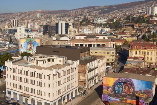 Large colourful murals decorating buildings in the old harbour area of Valparaiso in Chile