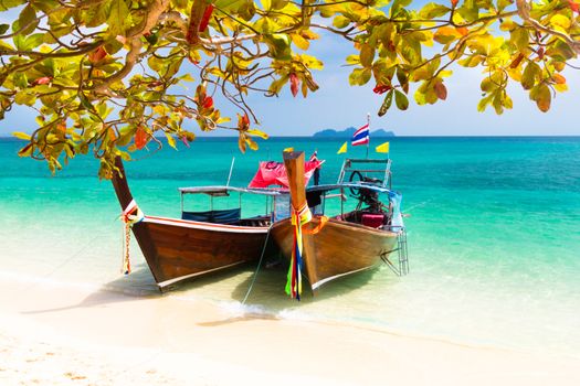 Traditional wooden long tail boats on a picture perfect tropical beach near Phuket, Thailand, Asia.