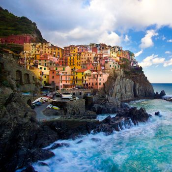 Manarola fisherman village in a dramatic wind storm. Manarola is one of five famous villages of Cinque Terre (Nationa park), suspended between sea and land on sheer cliffs upon the wild waves.