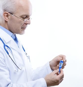 Senior male doctor measuring temperature with a thermometer.