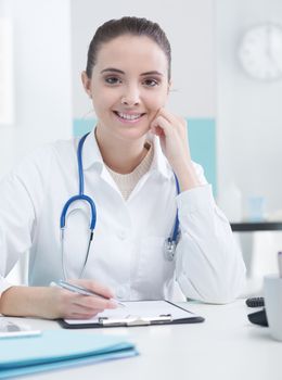 Smiling woman doctor or pharmacist in office 