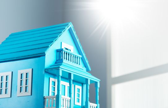 Blue model house with window on background.