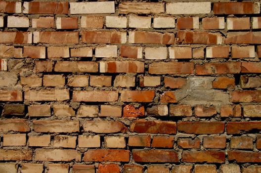 Background of Old Damaged Red Variegated Brick with Concrete Smoothing closeup