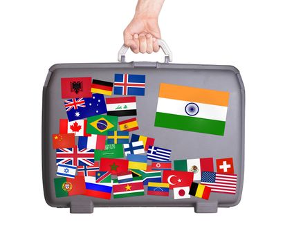 Used plastic suitcase with lots of small stickers, large sticker of India