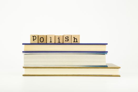 polish word on wood stamps stack on books, language and education concept