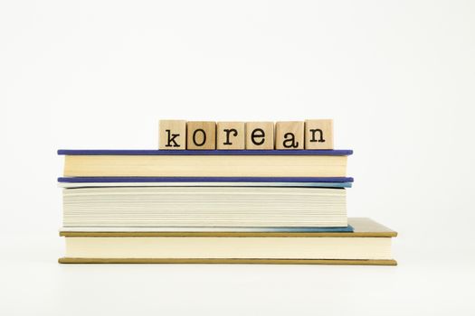 korean word on wood stamps stack on books, language and education concept