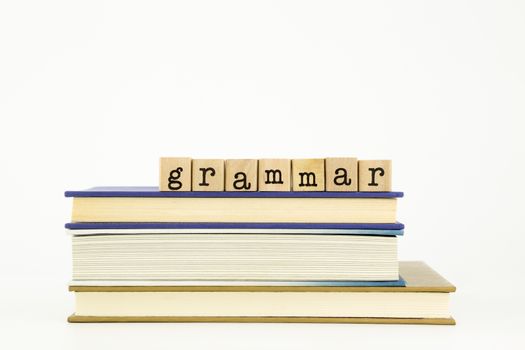 grammar word on wood stamps stack on books, language and education concept