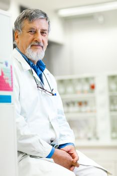 Senior male researcher carrying out scientific research in a lab (shallow DOF; color toned image)