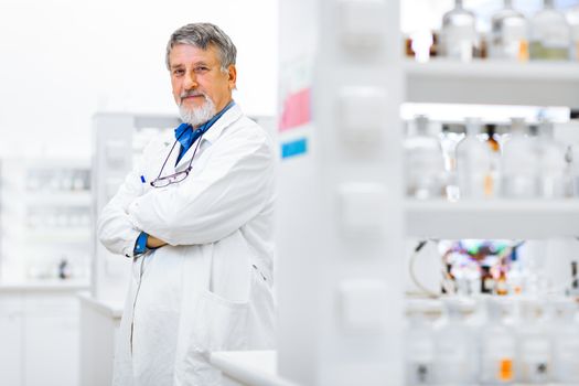 Senior male researcher carrying out scientific research in a lab (shallow DOF; color toned image)