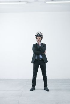 Confident businessman thinking with hand on chin wearing steampunk helmet 