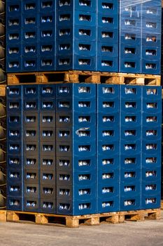 Several stacks of colorful beverage bottle crates outdoors