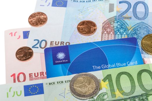 MUNICH, GERMANY - FEBRUARY 23, 2014: Global Blue Tax Free card against Euro notes and Cent coins. Isolate on white.