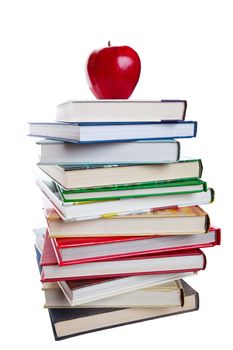 A stack of text books with a bright, red apple on top.  Shot on white background.