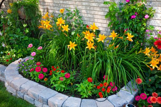 A stone edged, urban flower bed that packs a punch.  Small on size, but big on color!