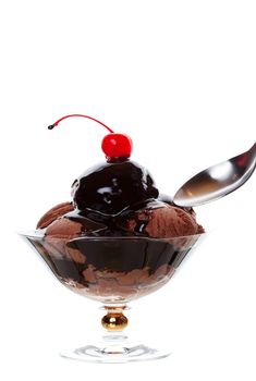 Chocolate sundae topped with a red cherry in an elegant sundae bowl.  Shot on white background.