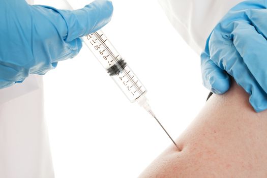 An H1N1 Influenza shot being injected into an arm.  