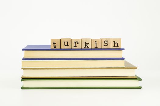 turkish word on wood stamps stack on books, language and academic concept