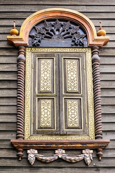 Antique wooden windows on the wooden wall