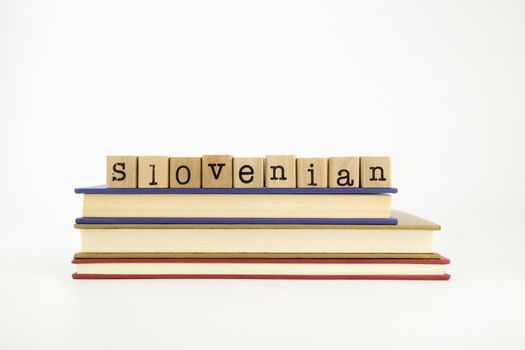 slovenian word on wood stamps stack on books, language and conversation concept