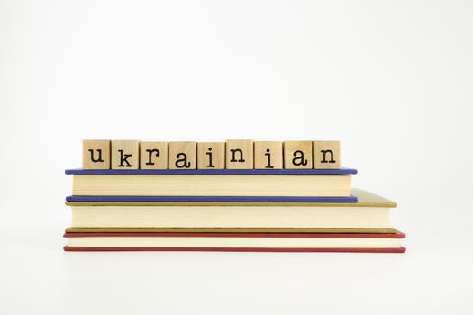 ukrainian word on wood stamps stack on books, language and conversation concept