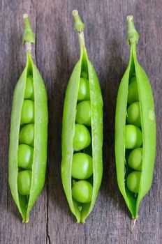 Fresh green peas on wooden table