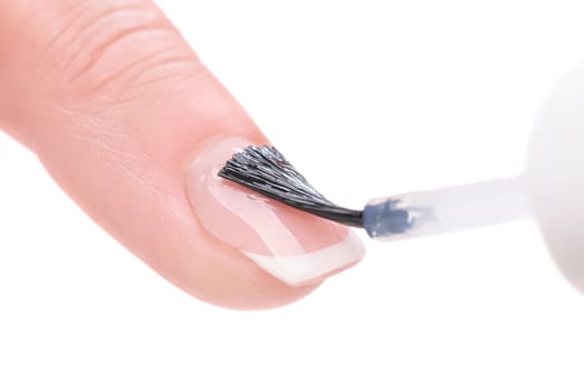 manicure applying, brushing fingernails with clear enamel