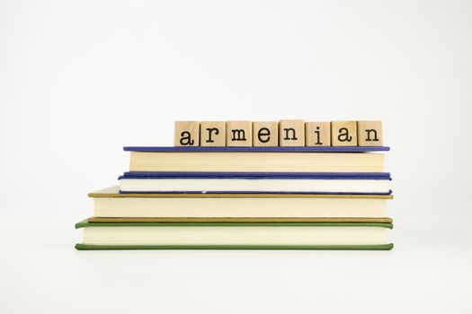 armenian word on wood stamps stack on books, language and conversation concept