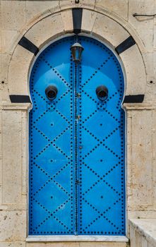 Blue Traditional door with arch from Sidi Bou Said in Tunisia
