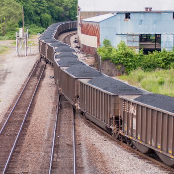 slow moving Coal wagons on railway tracks