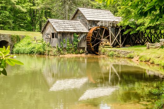 Historic Edwin B. Mabry Grist Mill (Mabry Mill) in rural Virginia on Blue Ridge Parkway and reflection on pond in summer