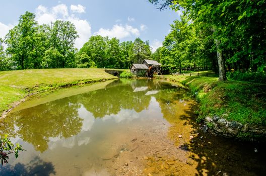 Historic Edwin B. Mabry Grist Mill (Mabry Mill) in rural Virginia on Blue Ridge Parkway and reflection on pond in summer