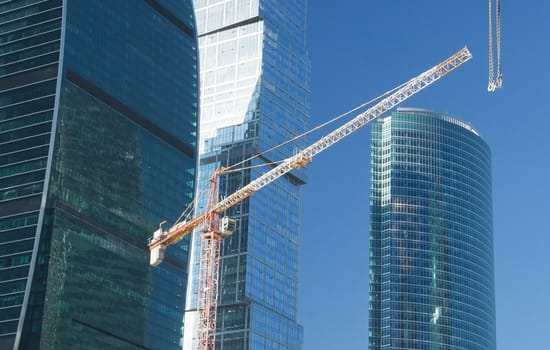 Elevating crane on construction of office buildings in the Moscow business center