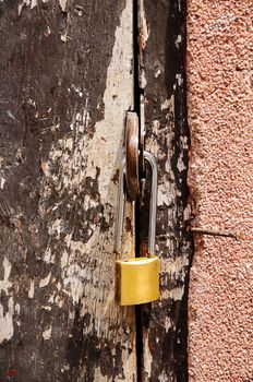 Padlock on a old wooden door 