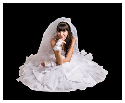 Bride in a white wedding dress on a black background in a sitting position