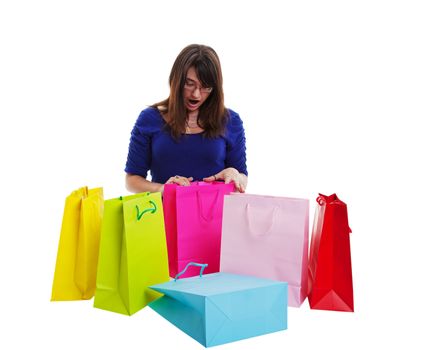 A teenage girl looking with surprise into a shopping bag.  Shot on white background.