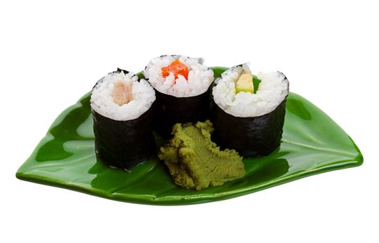 Three kinds of sushi on a leaf shaped plate.  Shot on white background.