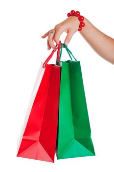 Christmas shopper with red and green shopping bags.  Shot on white background.