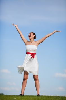 A beautiful, young woman enjoying the fresh air, sun, and being alive.