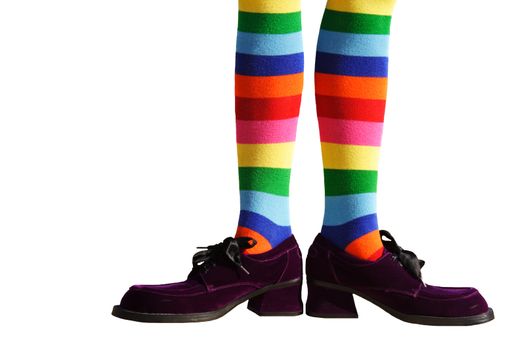 Wacky clown feet with crazy striped socks and oversized purple suede shoes!  Isolated.