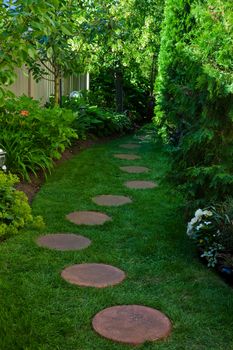 A side garden featuring a shady stepping stone path.